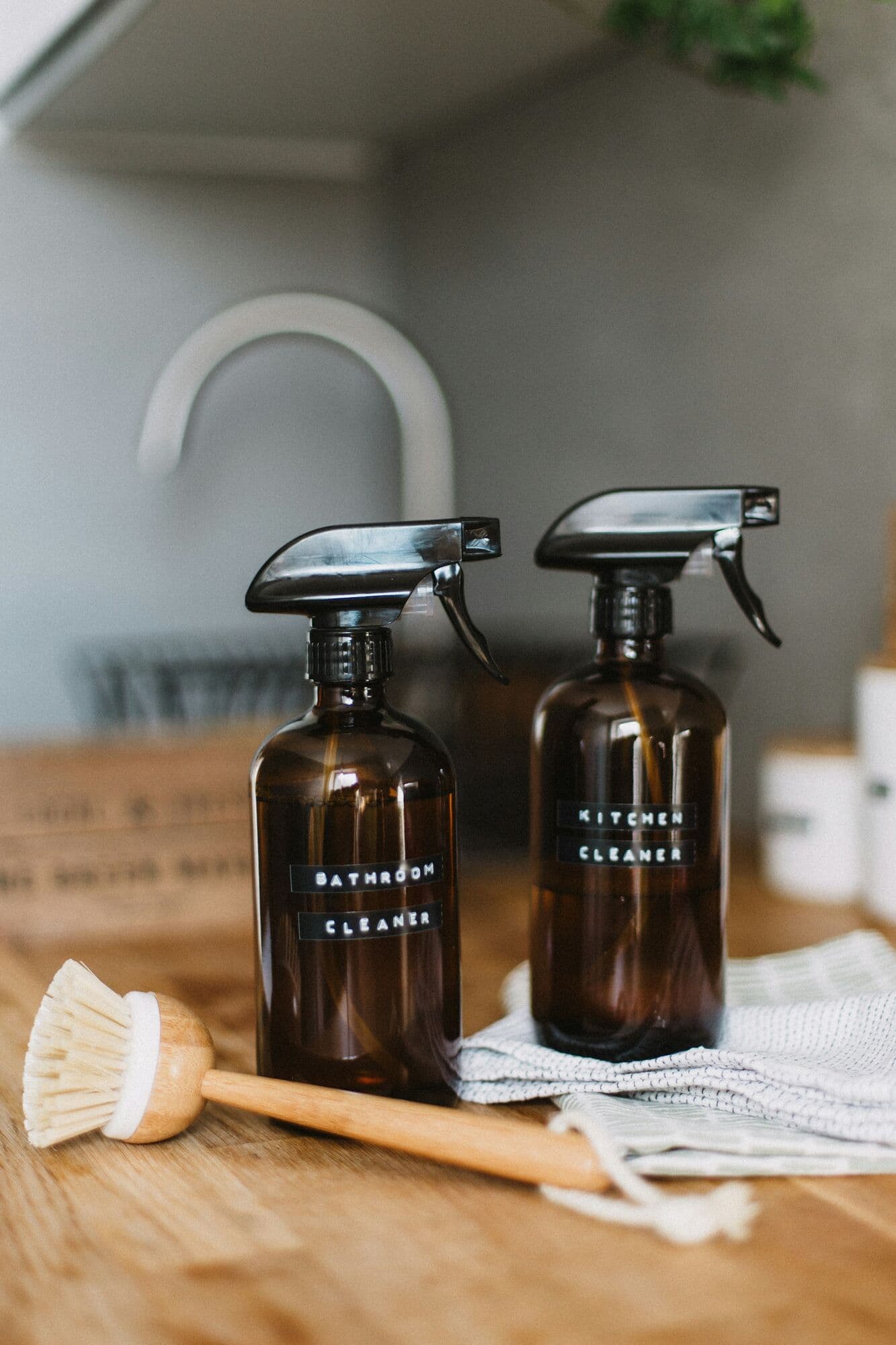 Amber glass spray bottles of kitchen and bathroom cleaner